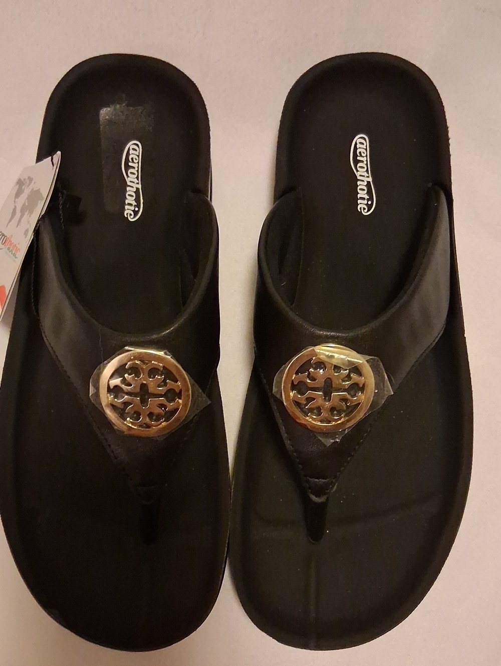 Aerothotic Women's Black Thong Sandals with Gold Medallion Accent